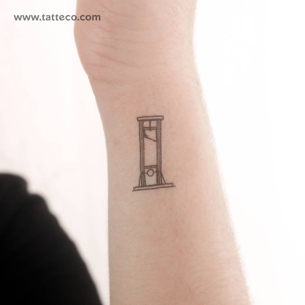 Fine line style guillotine temporary tattoo located on the wrist.