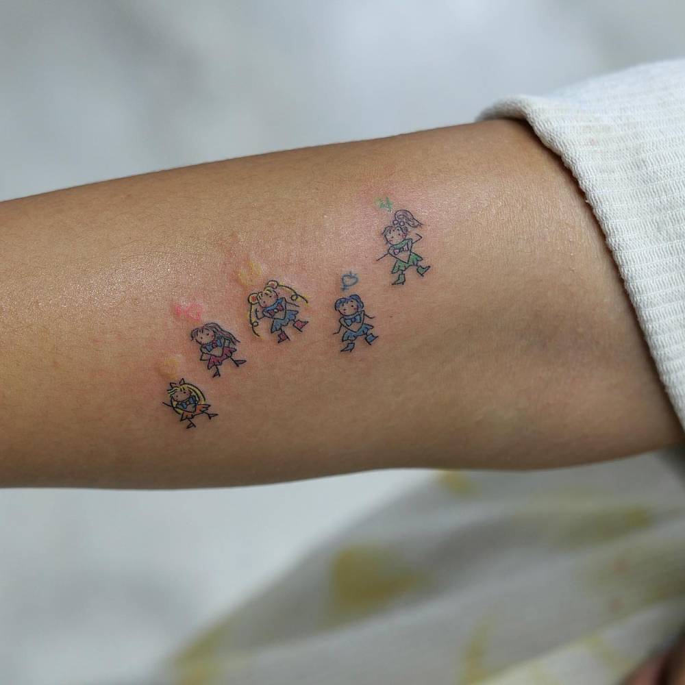 Cartoon style Sailor Moon tattoo located on the forearm.