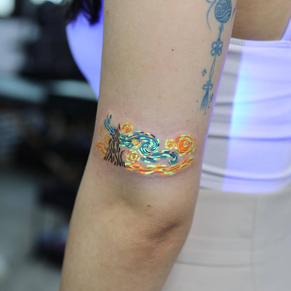 Contemporary style 'The Starry Night' tattoo located on the tricep.