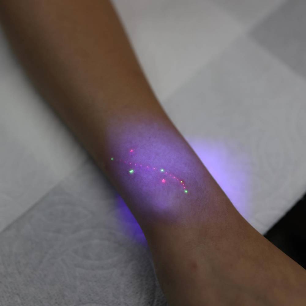 Minimalistic style Aries constellation tattoo located on the wrist.