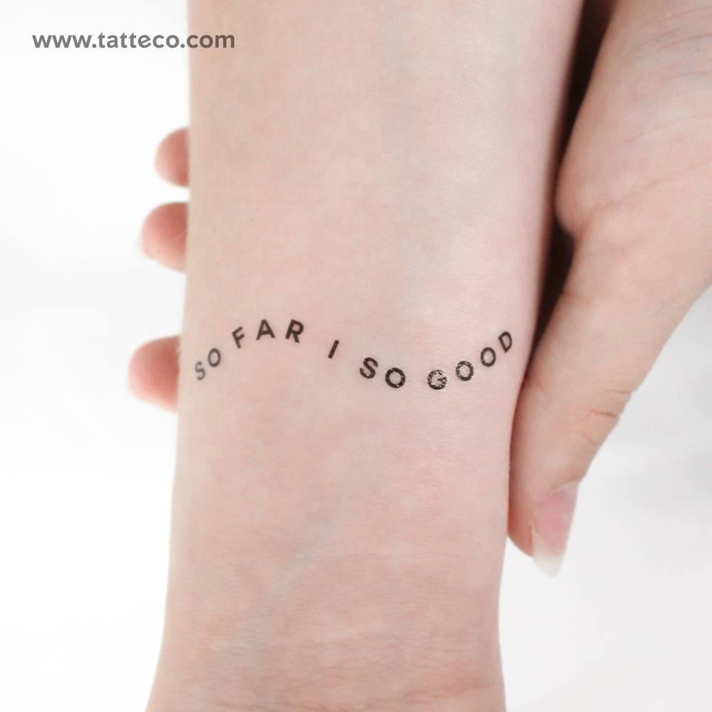 "So far so good" temporary lettering tattoo located on the wrist.
