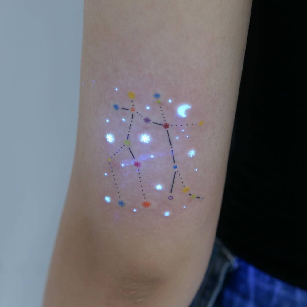Gemini constellation tattoo in Illustrative style done on the tricep.