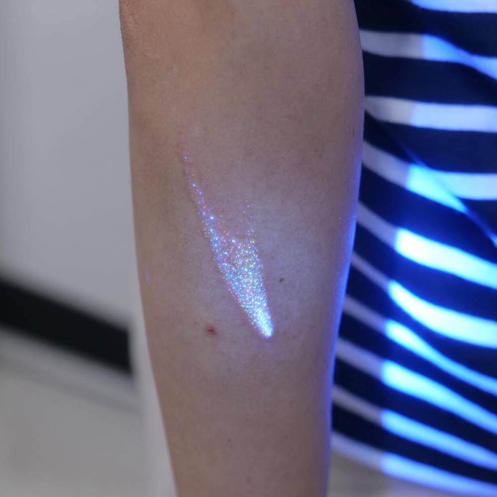 Glitter effect shooting star tattoo located on the forearm.