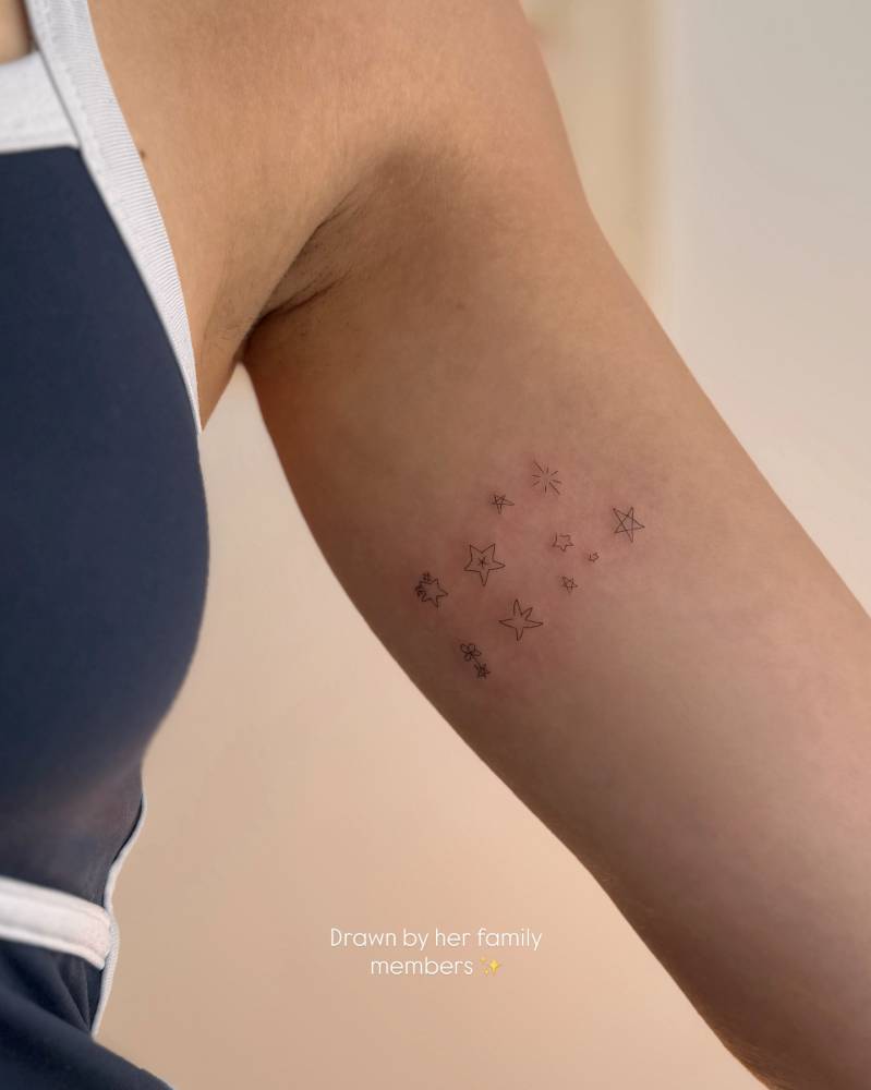 Star collection tattoo in minimalistic style located on the inner arm.