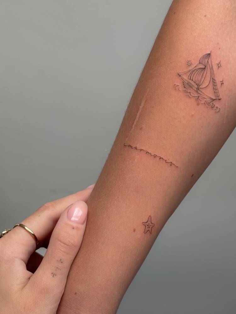 "Marmoris" lettering tattoo in handwritten font located on the forearm.
