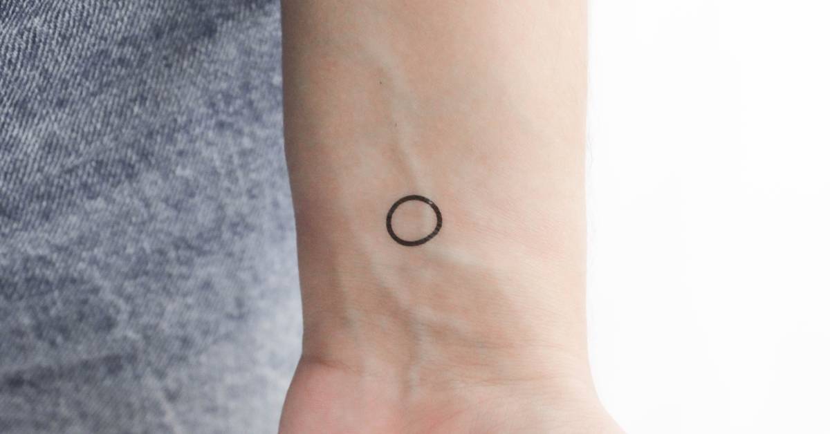 Little minimalistic circle temporary tattoo located on