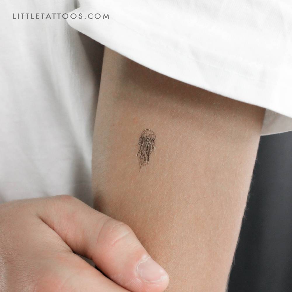 Illustrative style jellyfish temporary tattoo placed on the upper arm.
