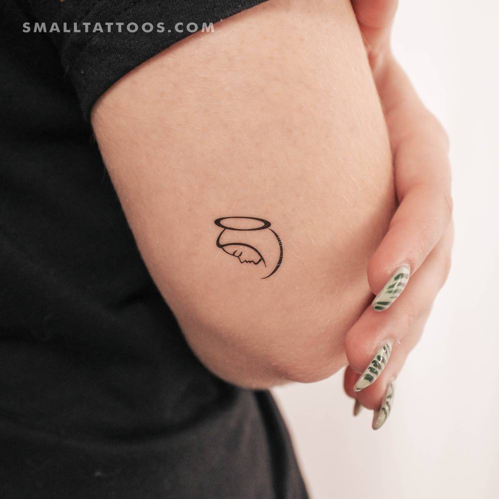 Minimalistic Virgin Mary temporary tattoo located on the tricep.