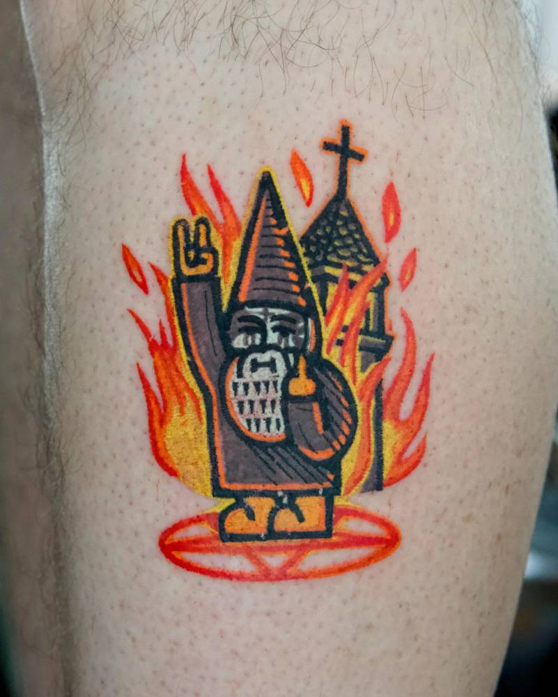 Arsonist gnome tattooed on the shin, pop art style.