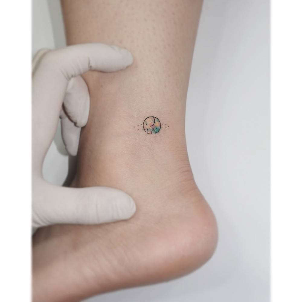 Minimalistic elephant tattoo located on the ankle.