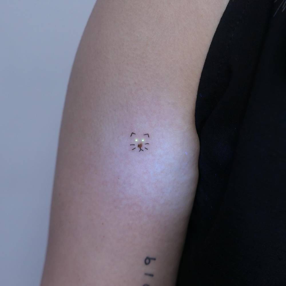 Tiny cat portrait tattoo covering up a birthmark.
