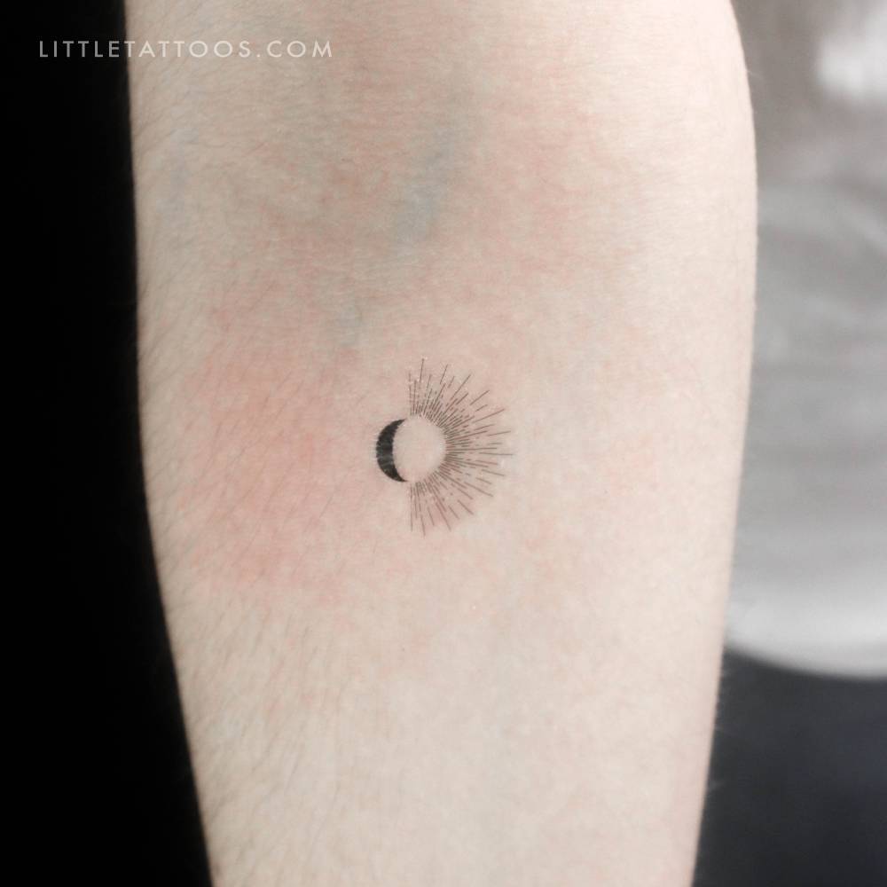 Half sun half moon temporary tattoo placed on the inner forearm.