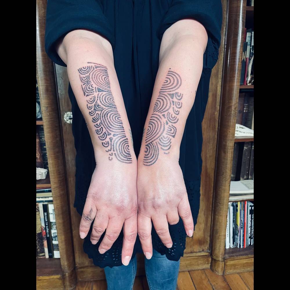 Forearm ornament tattoos done in dotwork style.