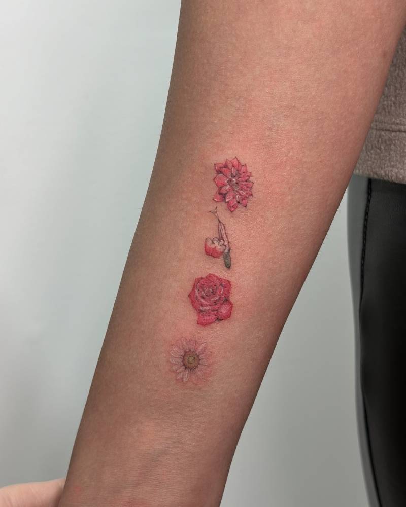 Illustrative style flower collection tattoo located on the wrist.