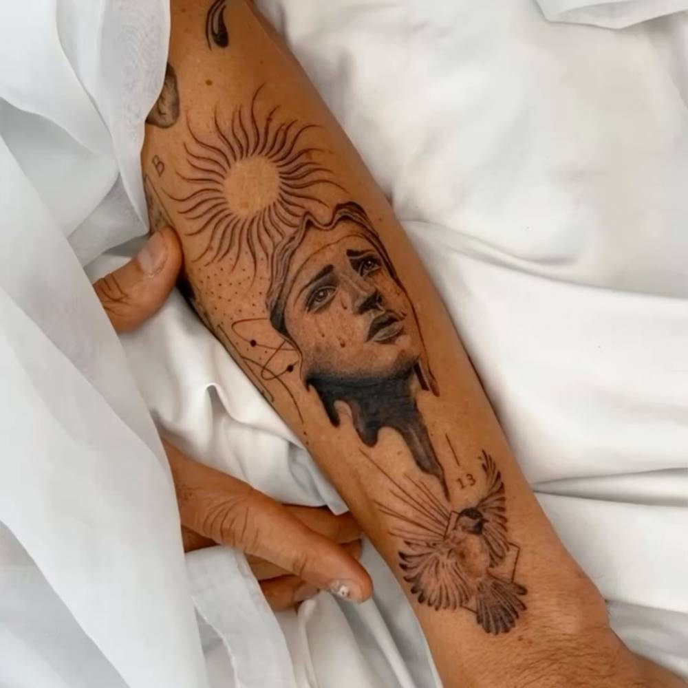 Our Lady of Sorrows tattoo located on the forearm, graphic style.