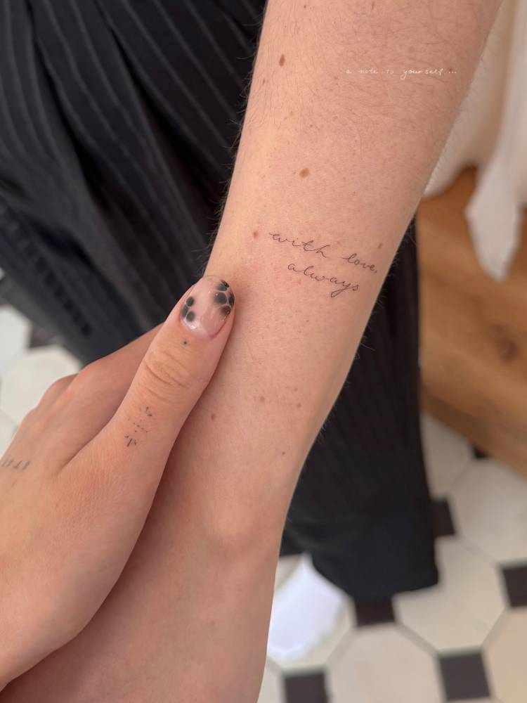 Handwritten font "with love, always" lettering tattoo placed on the wrist.