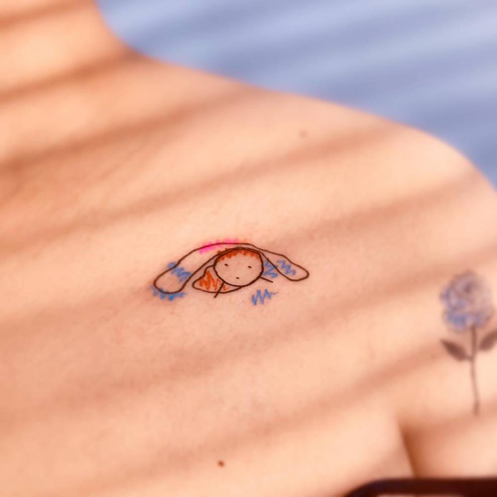 Cartoon style Ponyo tattoo located on the collarbone.