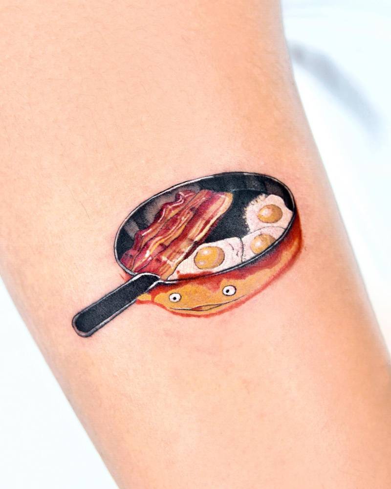 Howl's Moving Castle tattoo done on the upper arm.