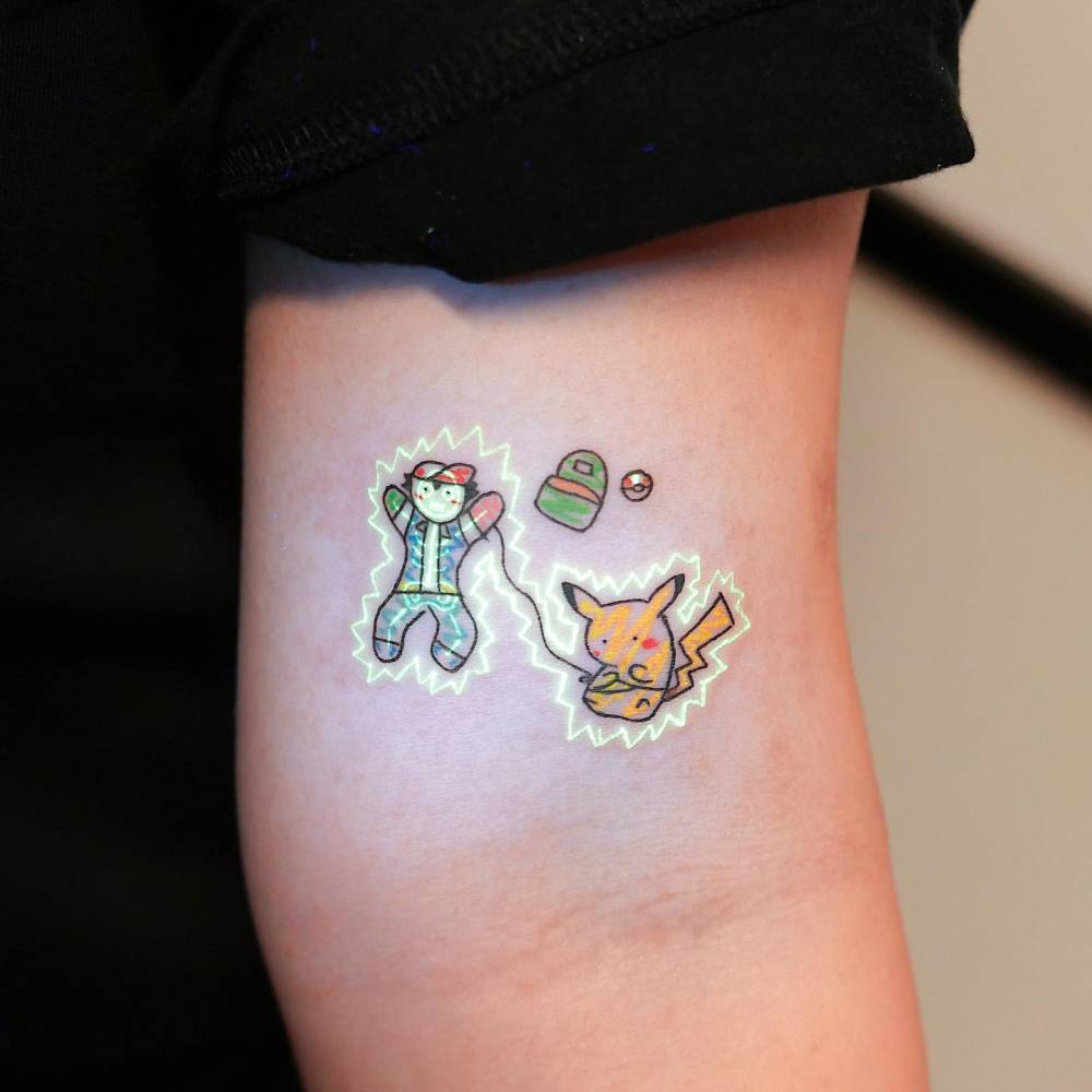 Ash Ketchum and Pikachu tattoo located on the bicep.