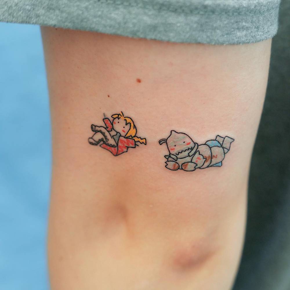 Cartoon style Fullmetal Alchemist tattoo placed on the tricep.