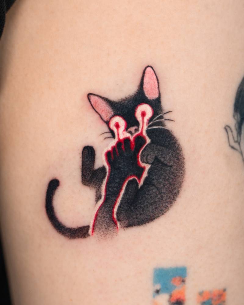 Pop art style black cat tattoo placed on the thigh.