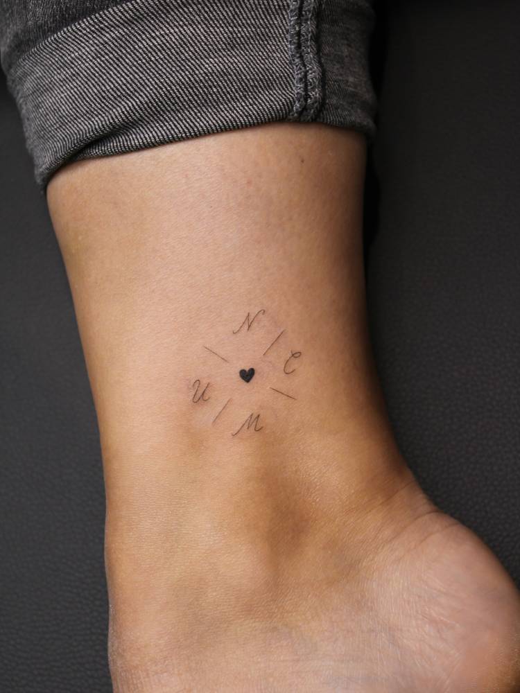 Initials and heart tattoo located on the ankle, minimalstic style.