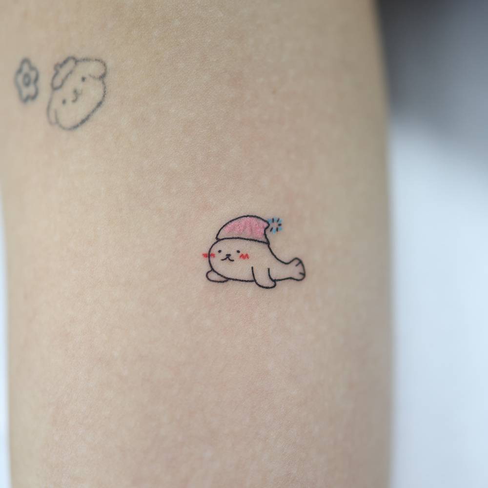 Cute little seal tattoo located on the forearm.