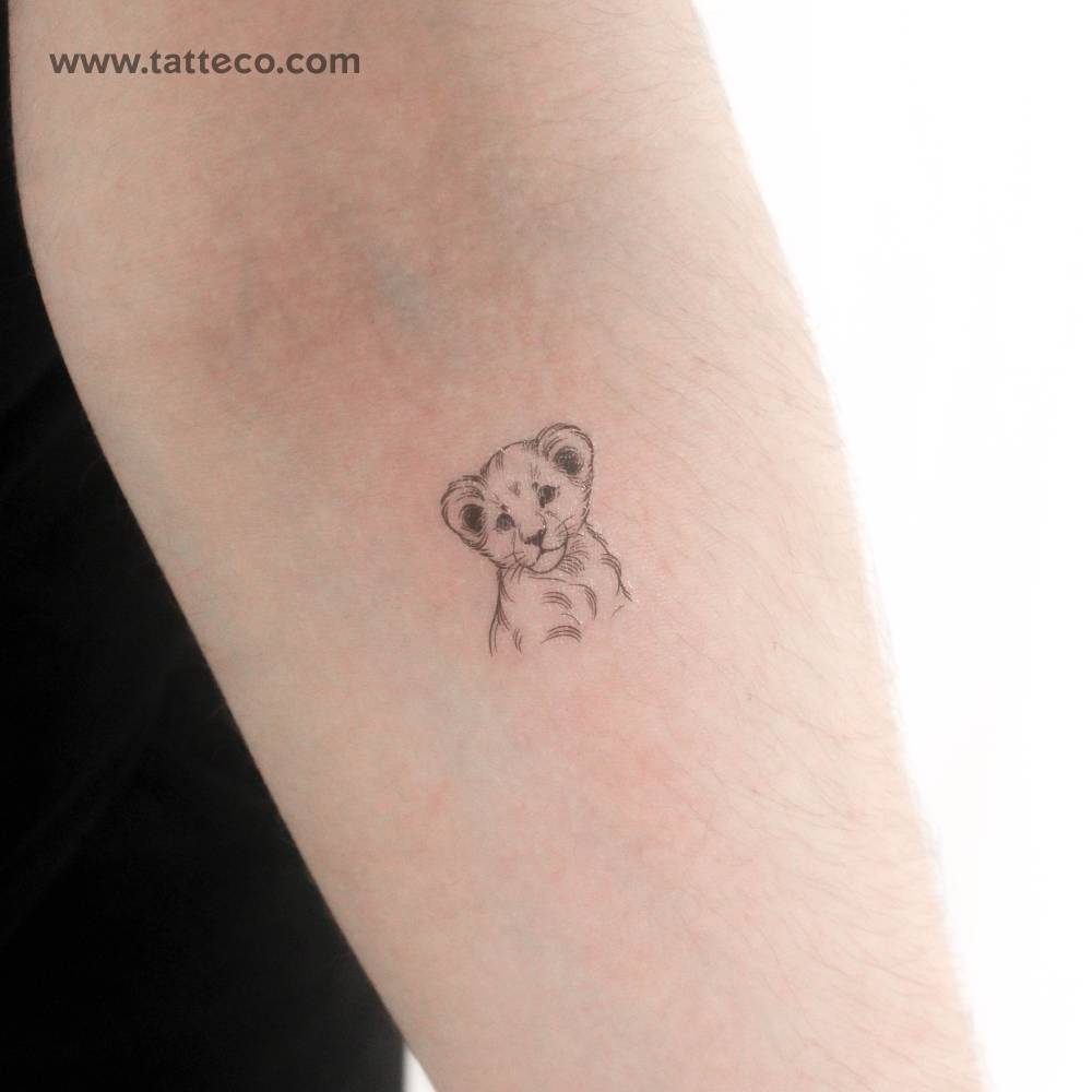 Illustrative style lion cub temporary tattoo located on the inner forearm.