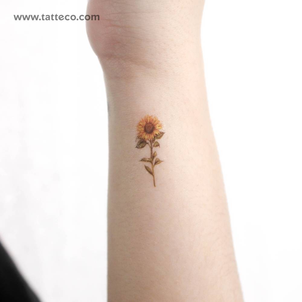 Small watercolor sunflower temporary tattoo located on the wrist.