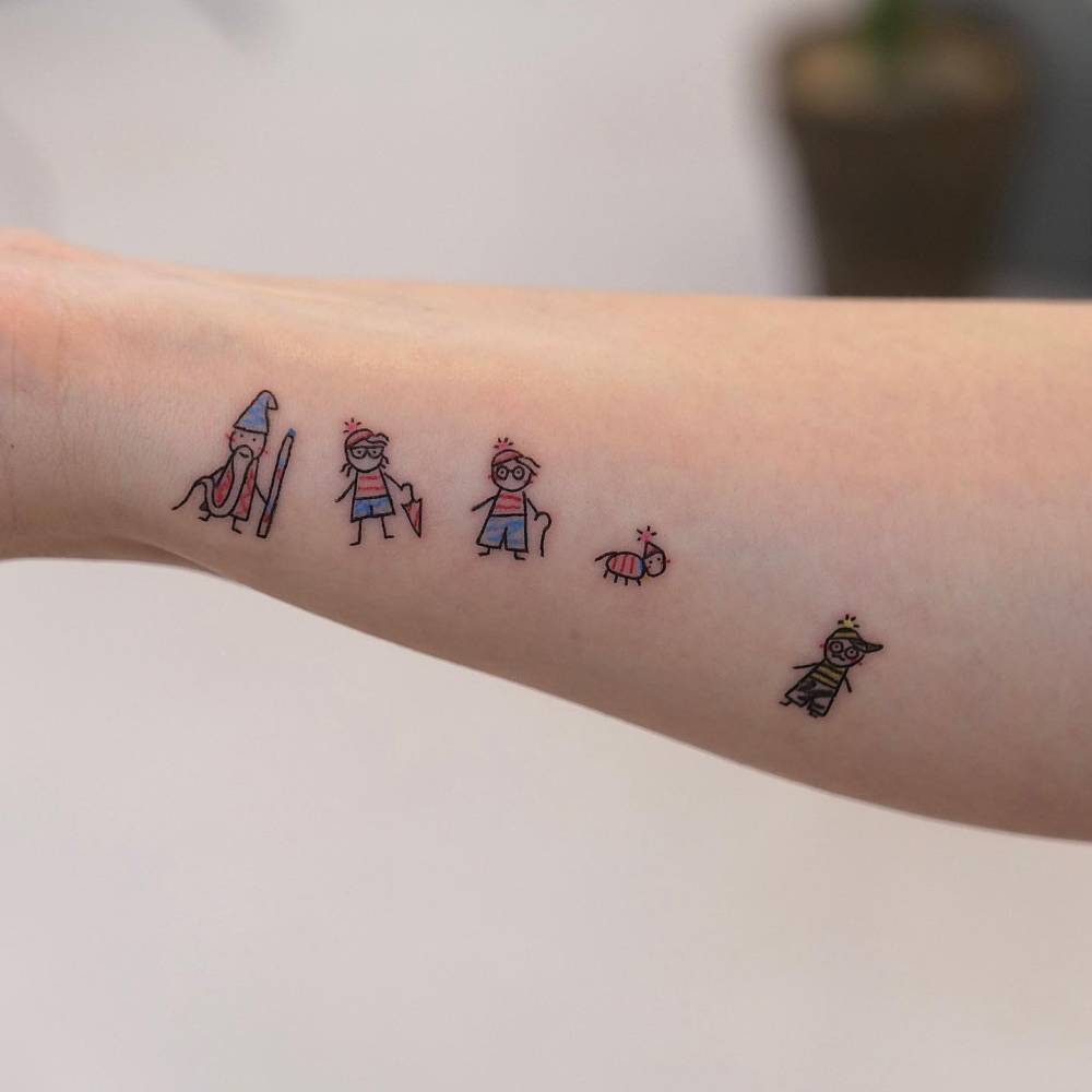 Where's Wally? tattoo located on the wrist, done in cartoon style.
