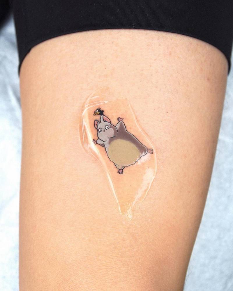 Spirited Away tattoo in cartoon style located on the inner arm.