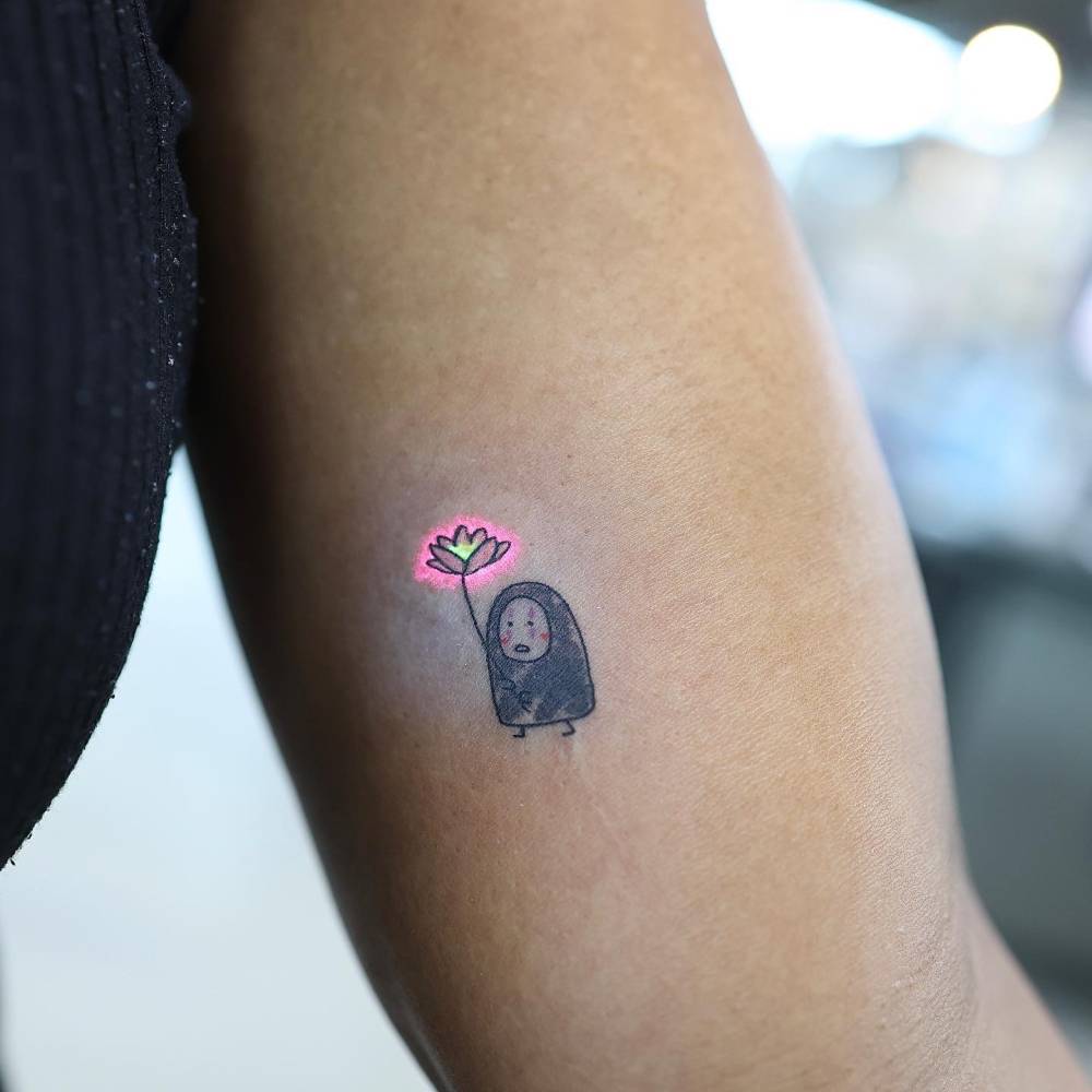 Little Kaonashi tattoo placed on the inner arm, done in cartoon style.