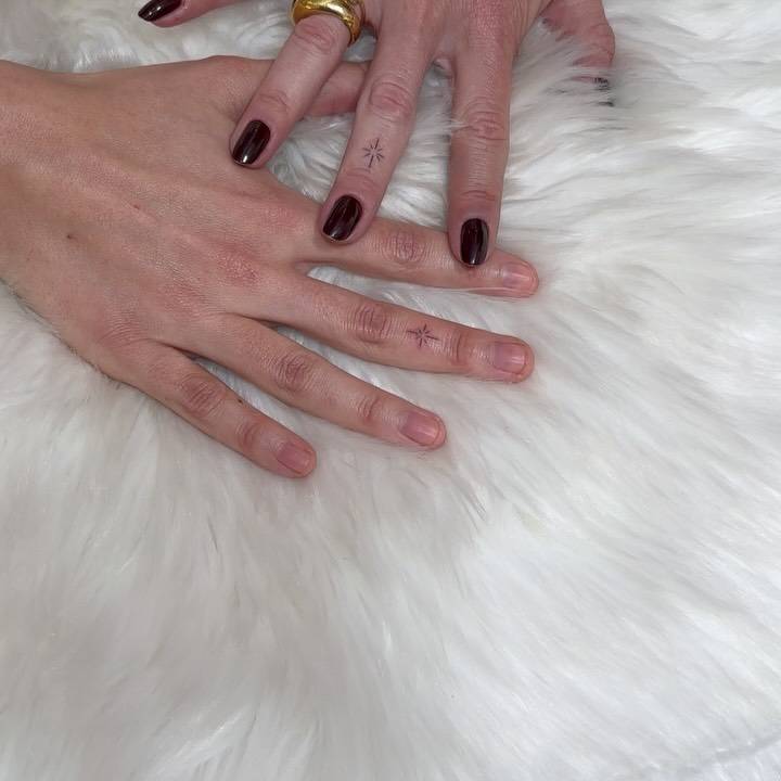 Matching minimalistic north star tattoo for couple.