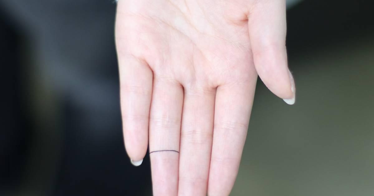 Little minimalistic ring tattooed on the finger.