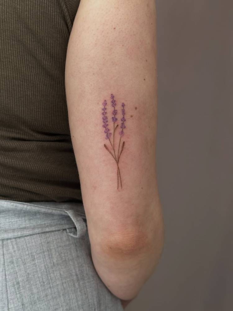 Illustrative style lavender tattoo located on the tricep.