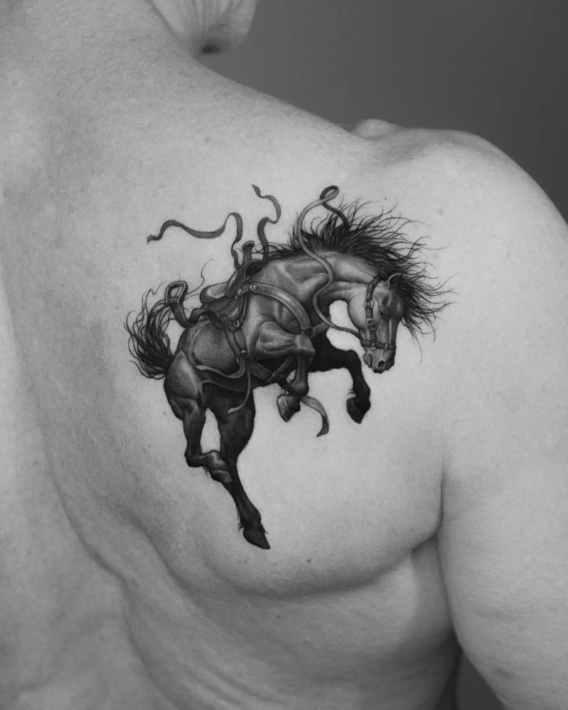 Horse tattoo in micro-realistic style located on the shoulder blade.
