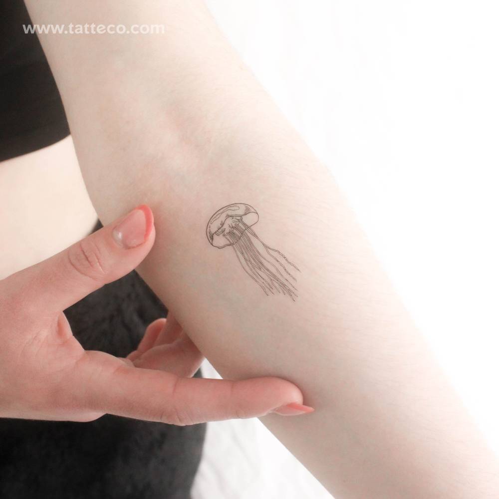 Fine line jellyfish temporary tattoo done on the inner forearm.