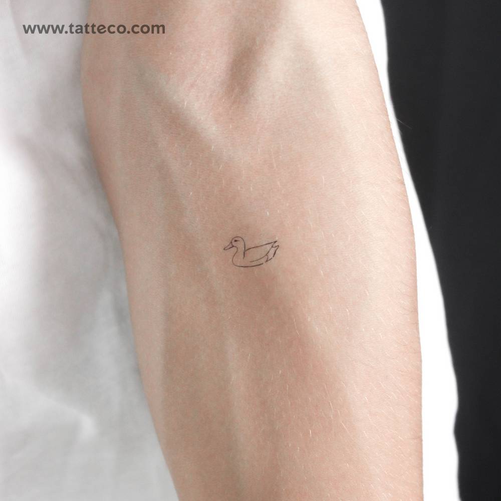 Fine line style tiny duck temporary tattoo located on the inner forearm.