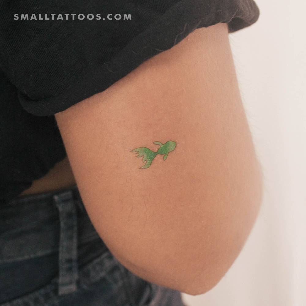 Little green fish temporary tattoo in watercolor style located on the tricep.