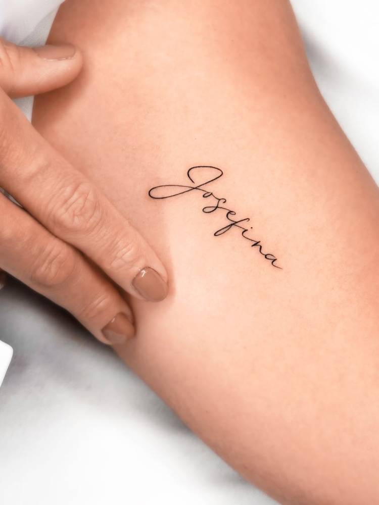 Name "Josefina" lettering tattoo located on the inner arm.