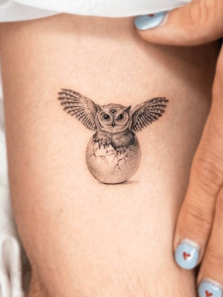 Cute owl tattoo in micro-realistic style done on the inner arm.