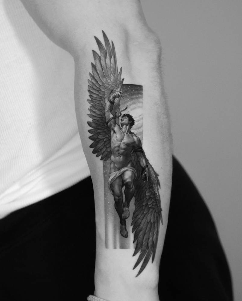 Micro-realistic style Icarus tattoo located on the forearm.