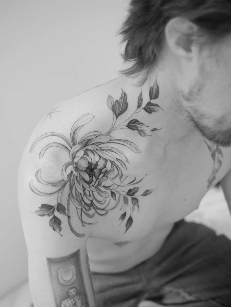 Illustrative style chrysanthemum tattoo located on the shoulder.