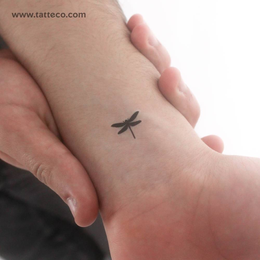Little black dragonfly temporary tattoo placed on the wrist.
