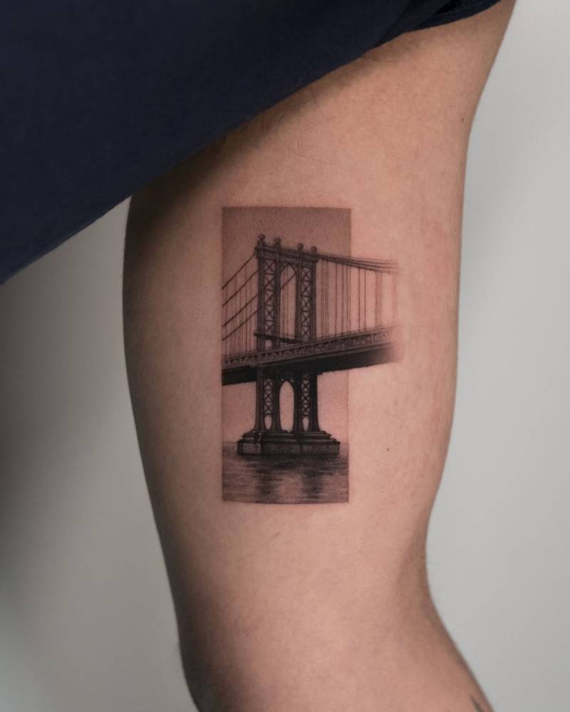 Manhattan Bridge tattoo located on the inner arm, micro-realistic style.