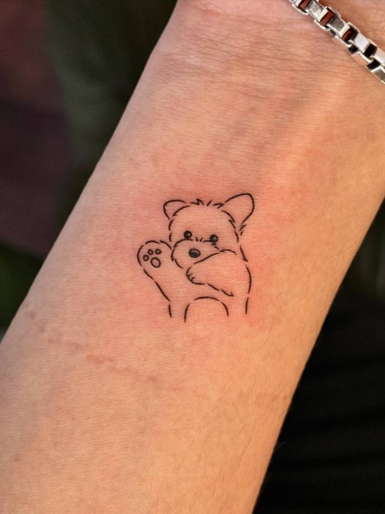 Yorkshire Terrier tattoo in minimalistic style located on the wrist.