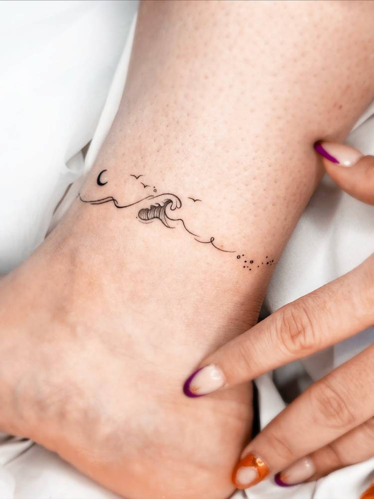 Wave ankle band tattoo in fine line style.