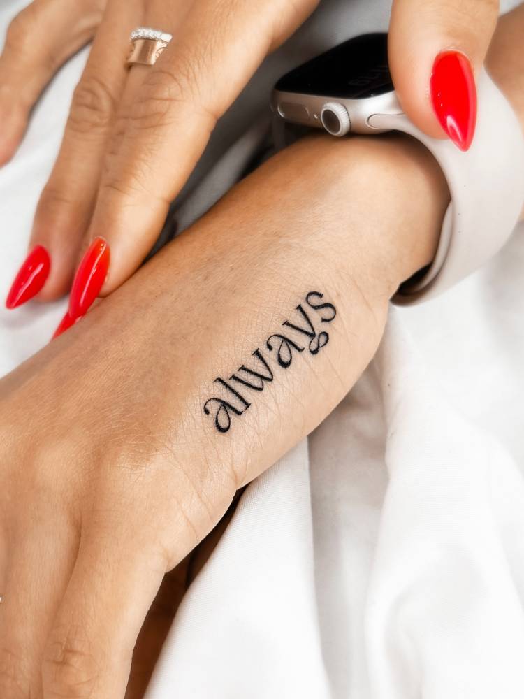 Lettering tattoo of the word "always" located on the hand.