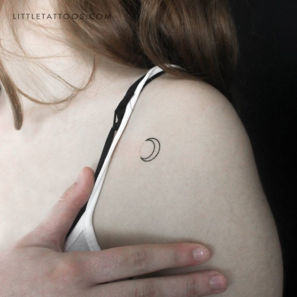 Minimalistic style crescent moon and dots temporary tattoo located on the shoulder.