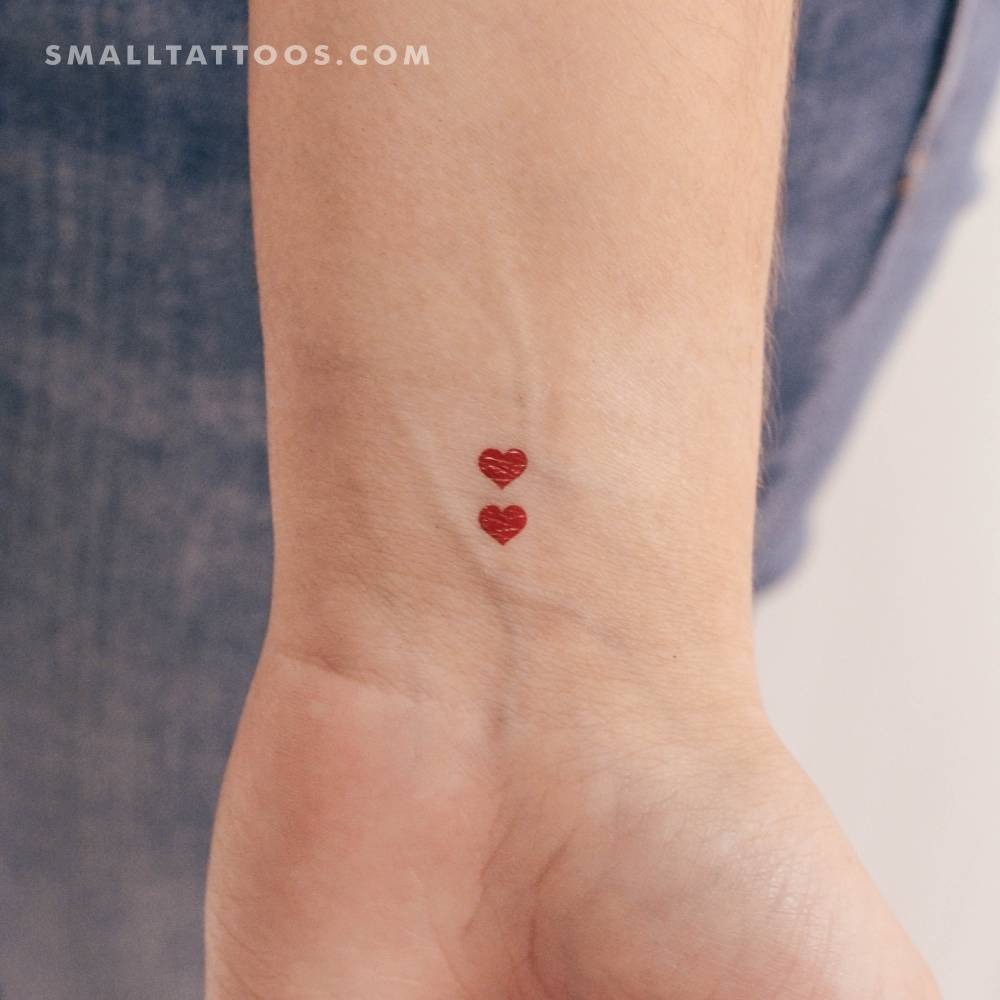 Two minimalistic red hearts temporary tattoo located on the wrist.